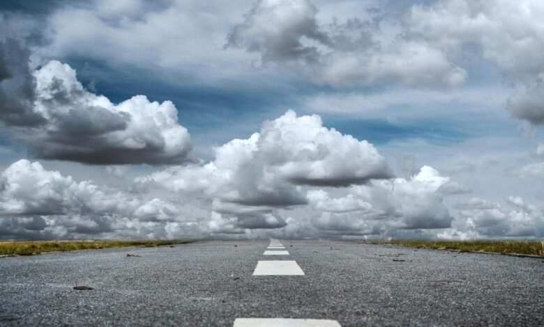 gray rolled asphalt road under cloudy sky