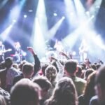 crowd in front of people playing musical instrument during nighttime