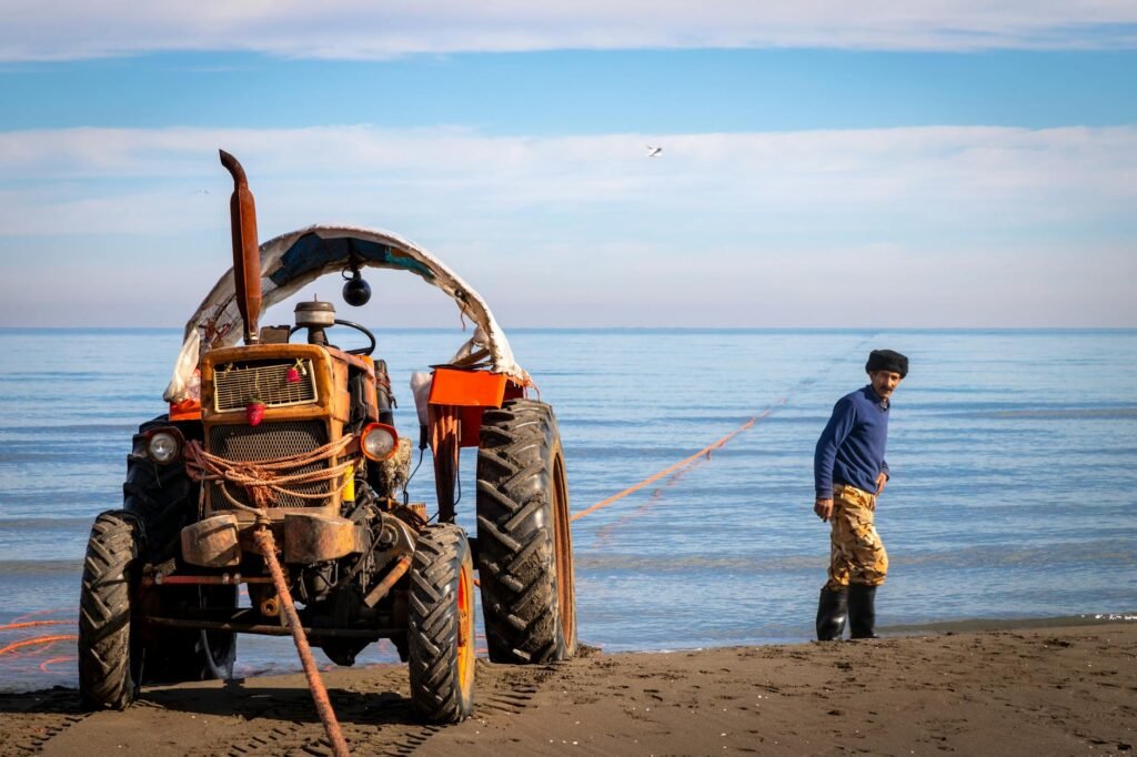 tractor by fisherman on sandy beach