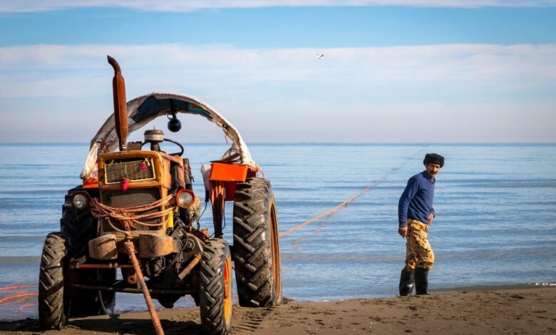 tractor by fisherman on sandy beach