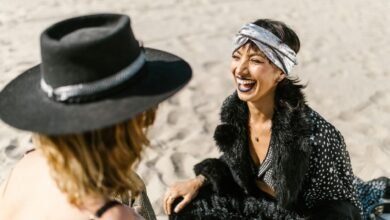 two women sitting on the beach