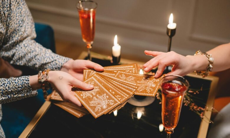 close up of woman picking a tarot card from a deck held by another woman