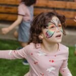 a girl running on the green grass