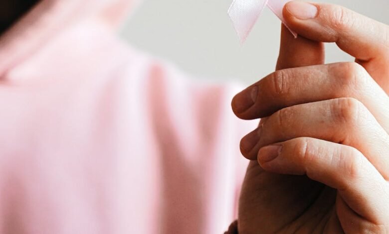 woman holding pink ribbon