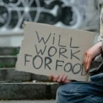 person holding a cardboard poster