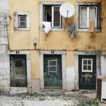 white parabolic antenna beside brown concrete building