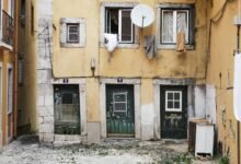 white parabolic antenna beside brown concrete building