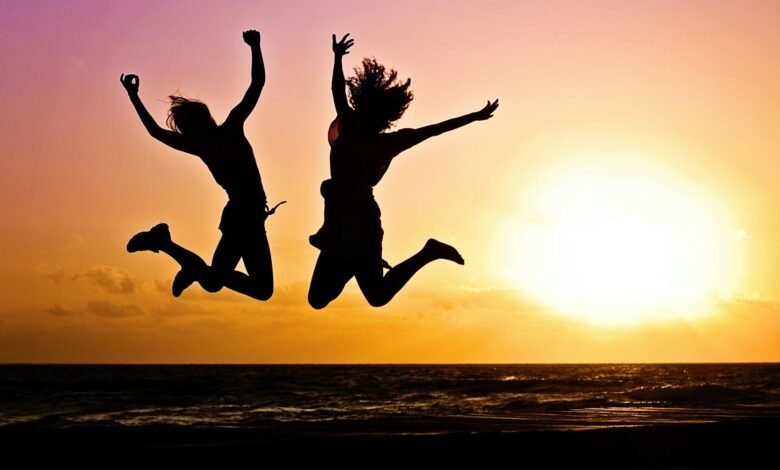 silhouette photography of jump shot of two persons